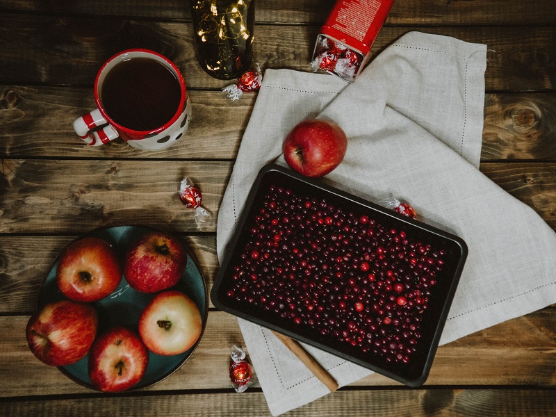 Cranberry Tea Recipes Cranberries on a Tray Surrounded by Apples and Drinks