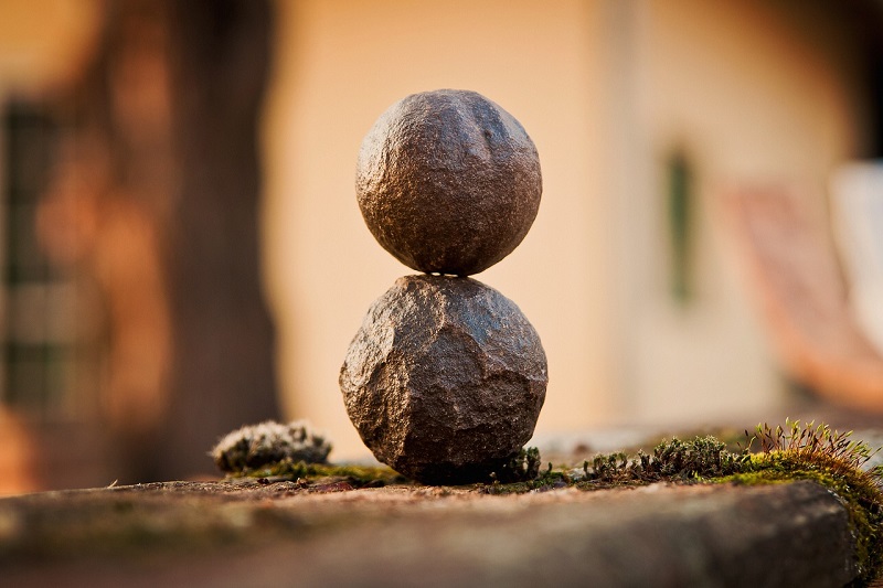Passive Income Made Easy Two Round Rocks Stacked on Each Other