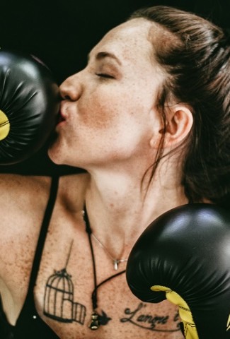 Funny Workout Quotes for Women A Woman Wearing Boxing Gloves Kissing the End of One of the Gloves