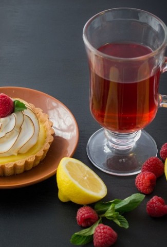 Herbalife Tea Flavors A Cup of Tea with Lemons and Raspberries Around It