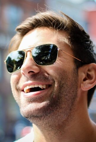 Tips to Detox your Life Close Up of a Man Wearing Sunglasses and Smiling