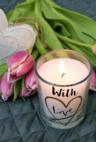 Inspirational February Quotes Everyone Needs Overhead View of Flowers with a Candle and a Heart-Shaped Wooden Piece