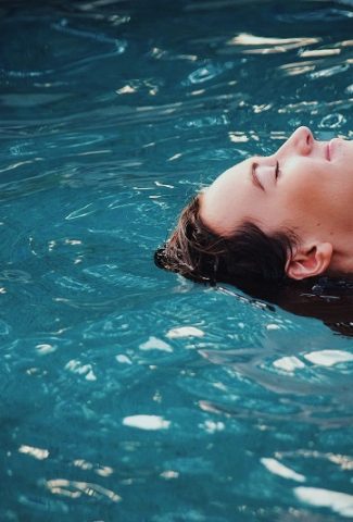 Toning Exercises to Look your Best in Summer Close Up of a Woman's Face as She Floats in a Pool of Water